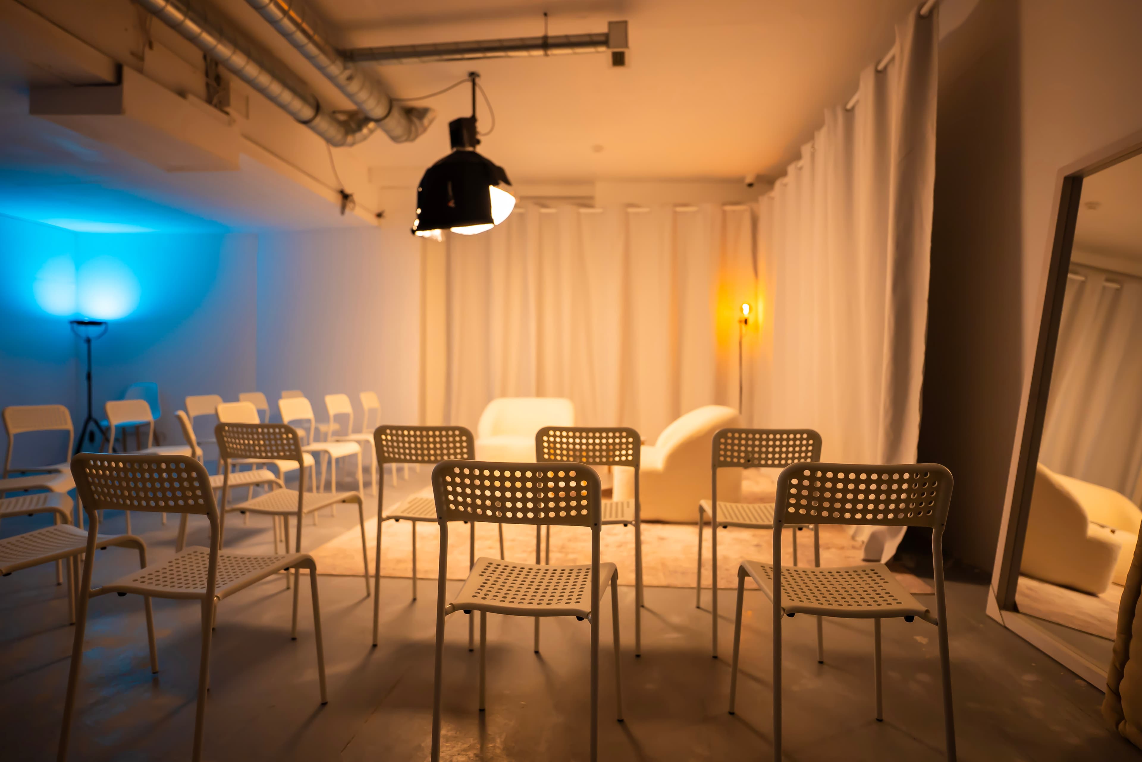 Event space with chairs and blue accent lighting at Film Büro Lisbon