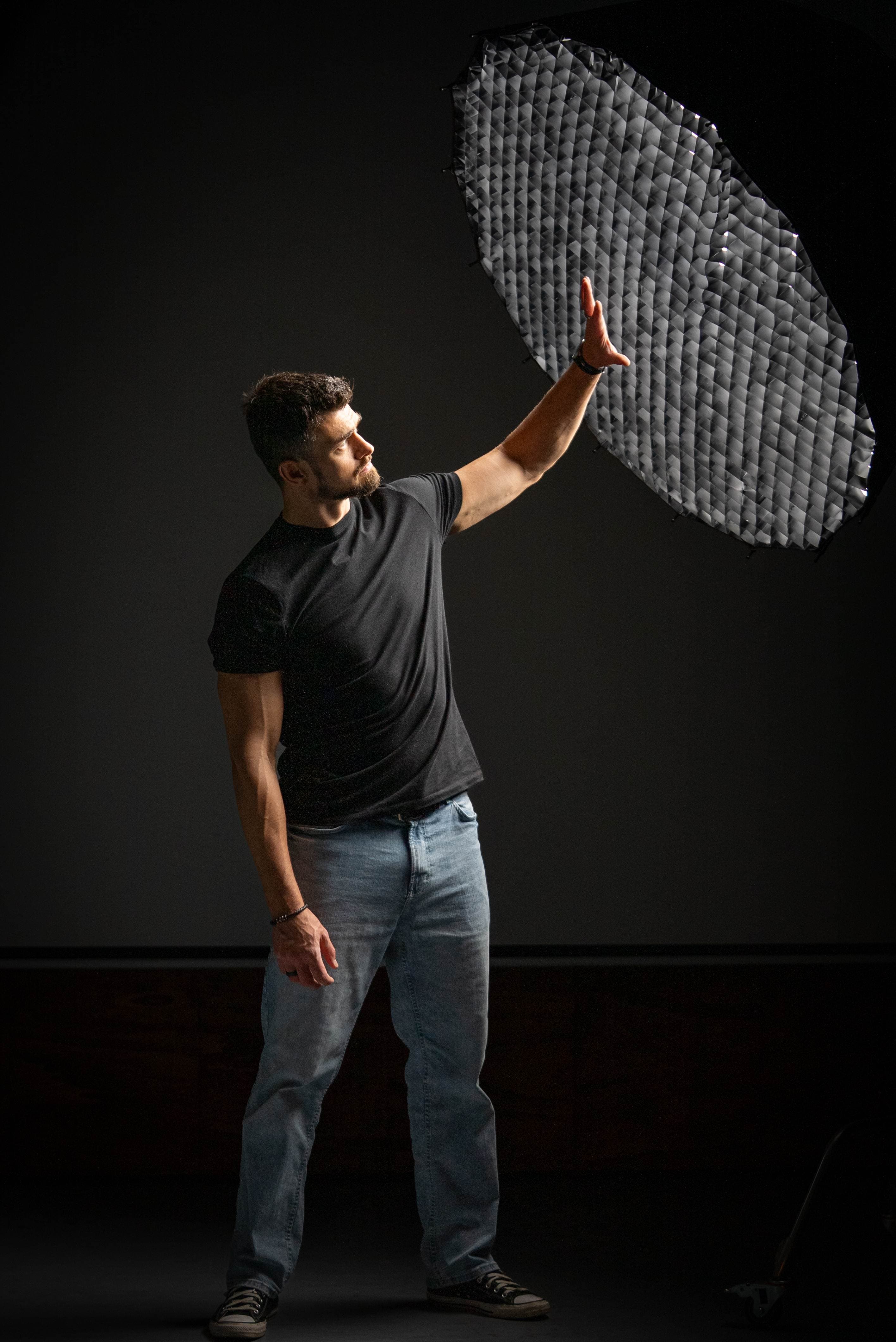 Cinematographer adjusting professional softbox lighting