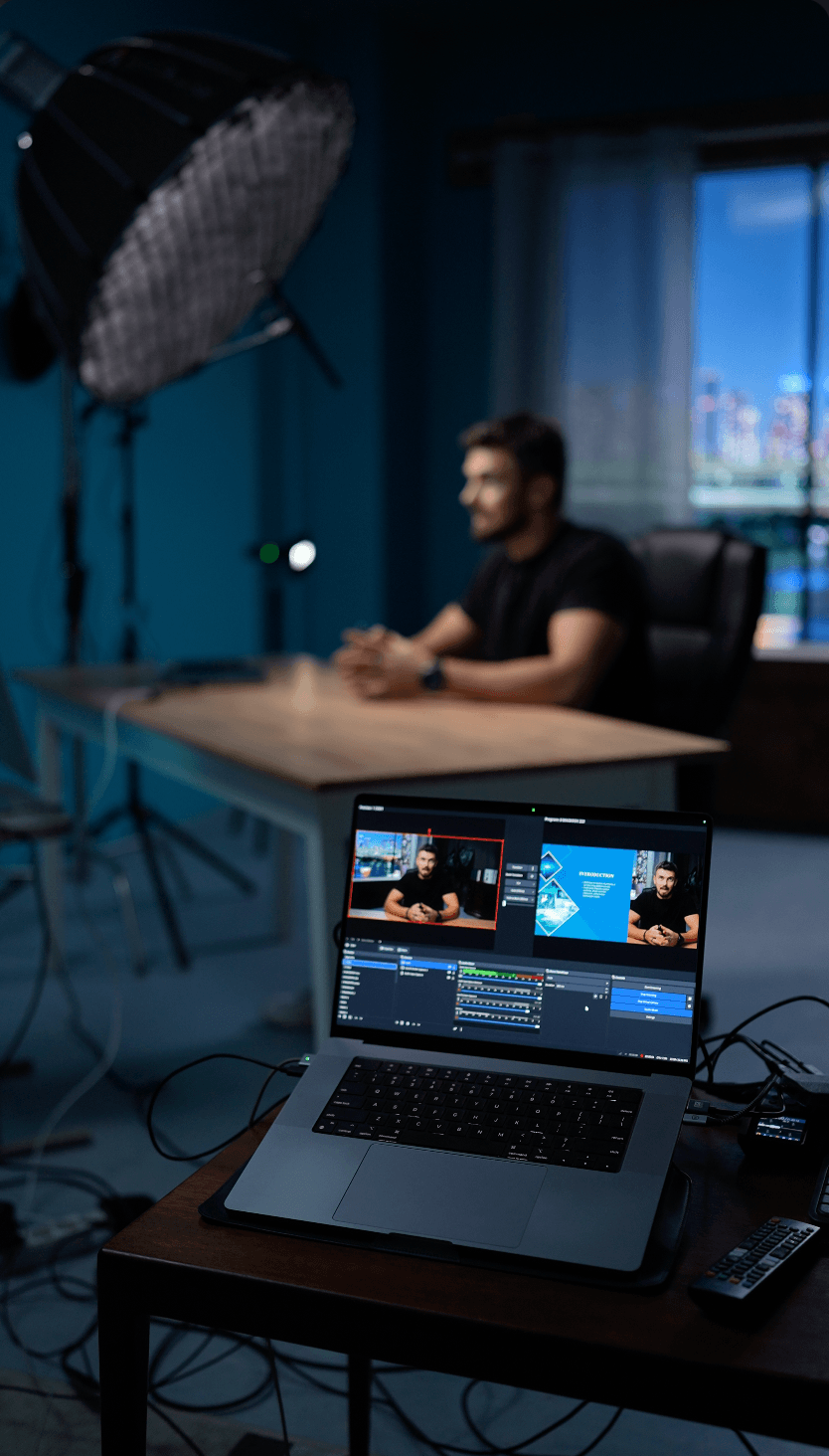 Live webinar studio at Film Büro Lisbon with laptop showing streaming software and professional lighting setup