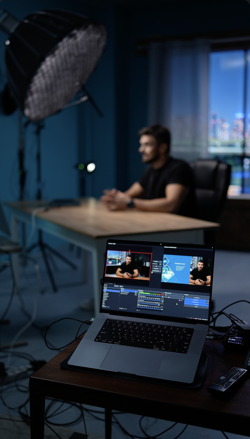 Live webinar studio at Film Büro Lisbon with laptop showing streaming software and professional lighting setup
